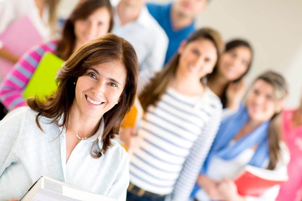 Female teacher with group of students at the university-1