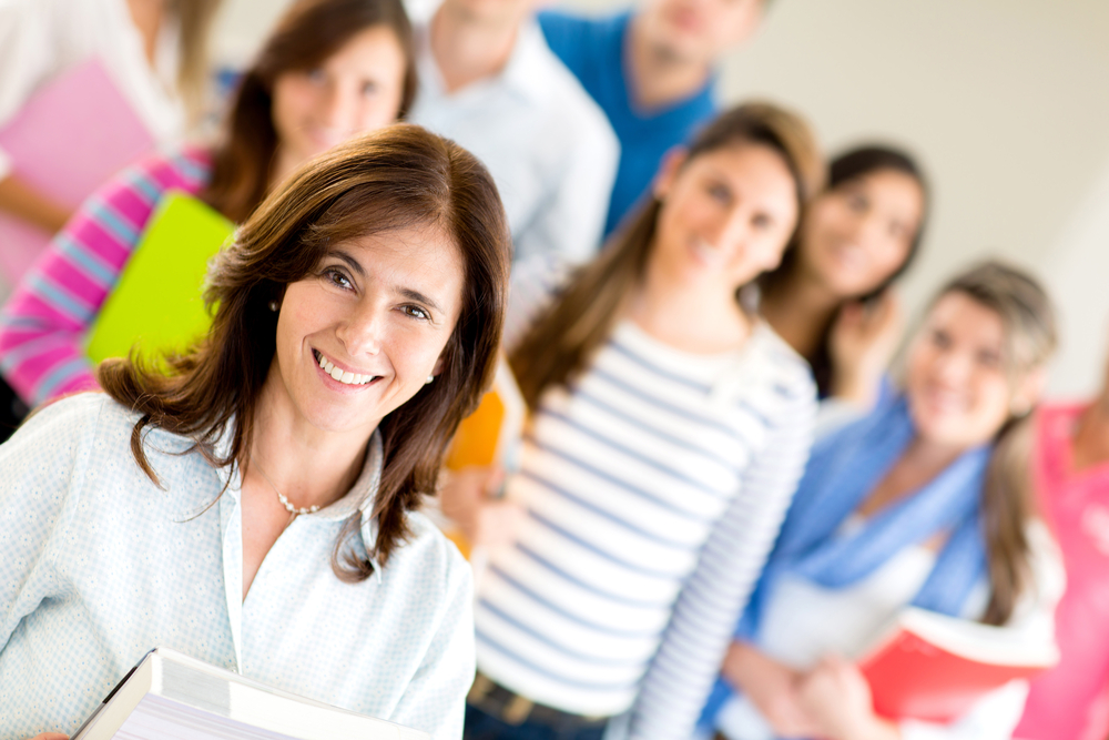 Female teacher with group of students at the university